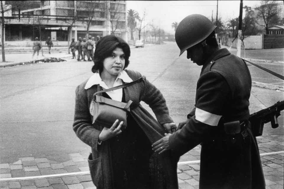 Chili, Santiago september 1973. A woman is being searched on the street during the military coup.
