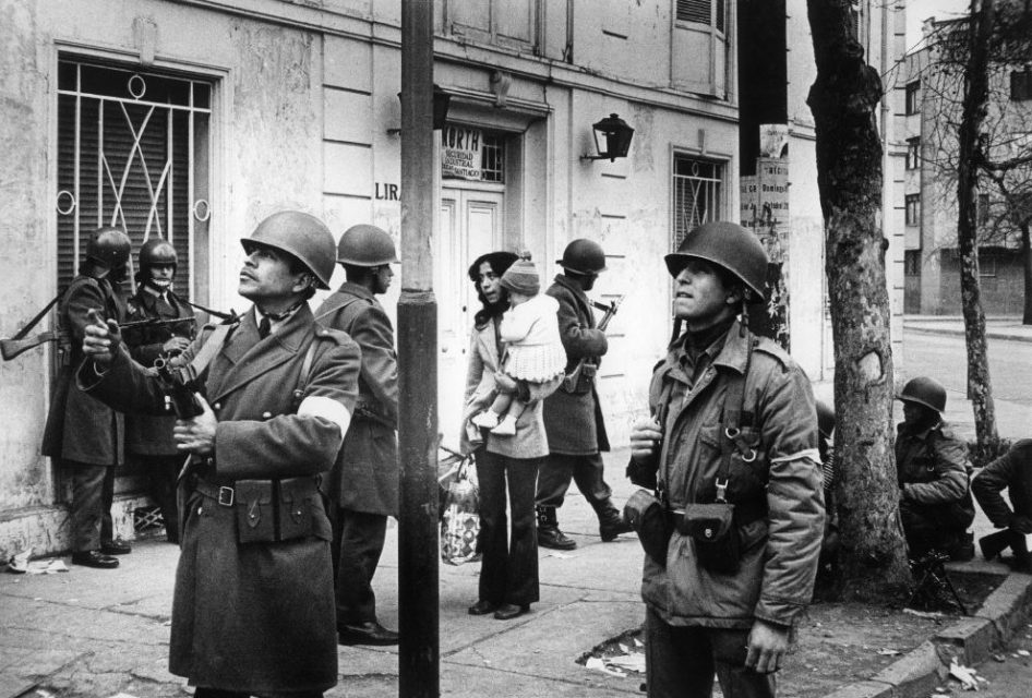 Chili, Santiago, september 1973. Several days after the military coup. Mother and her child amongst soldiers on the street.