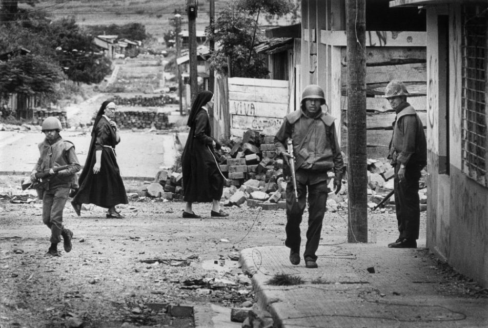 Nicaragua, Esteli, 1978. Street view with soldiers and nuns. 