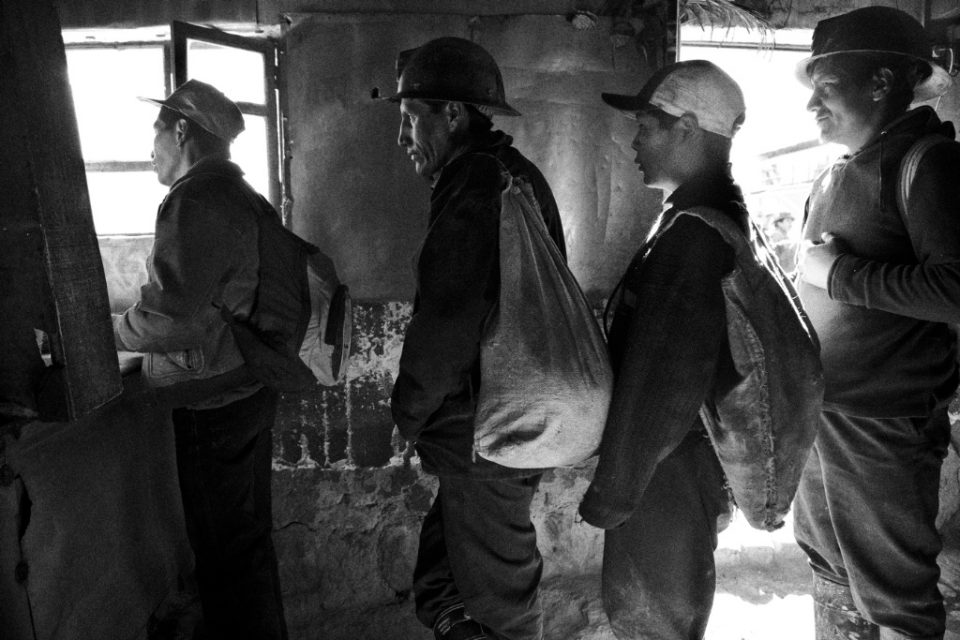 Miners have breakfast before entering the mines.

The mines in Siglo XX opened in 1900, attracting thousands of workers from all over. But the market went slowly down and in 1986 the government (the mine was nationalized in 1952), to close down the mine all together. The miners didn't accept this decision and formed coorperatives to be able to continue working. Nowadays about 5000 miners work again in the mine attracted by the high tin price. 
At an altitude of 4000 metres, in a mine with temperatures up to 50 degrees, no elevators, no electricity and all manual labour; the work is dangerous and life expentancy is not higher then 45 years.