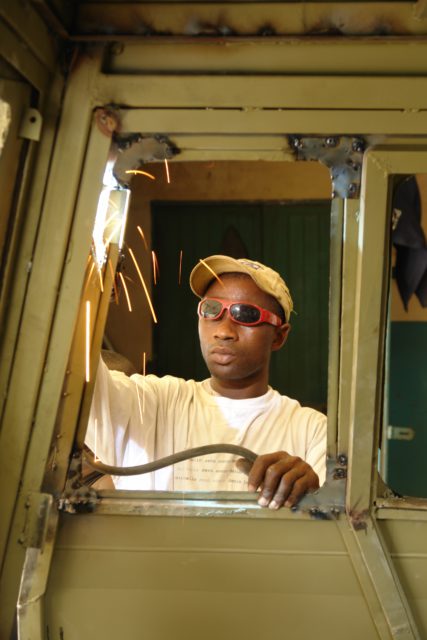 A welder working on one of the Turtle's doors. 