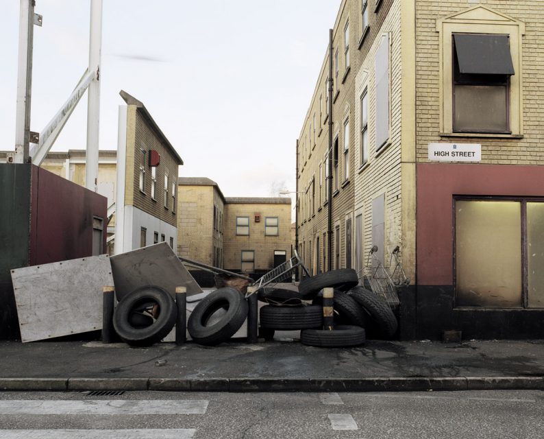 High Street Barricade from the series Public Order (2003-2005). In this photo series, Sarah Pickering documented a model city which is used by the English police. 