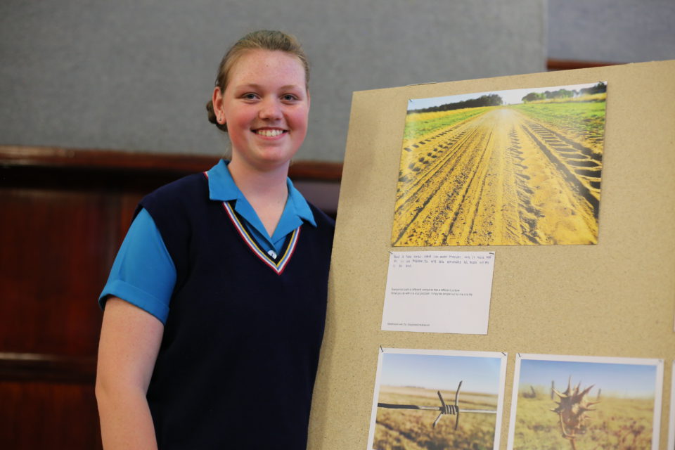 A student with her photos, themed 'Who am I in 2017?' 