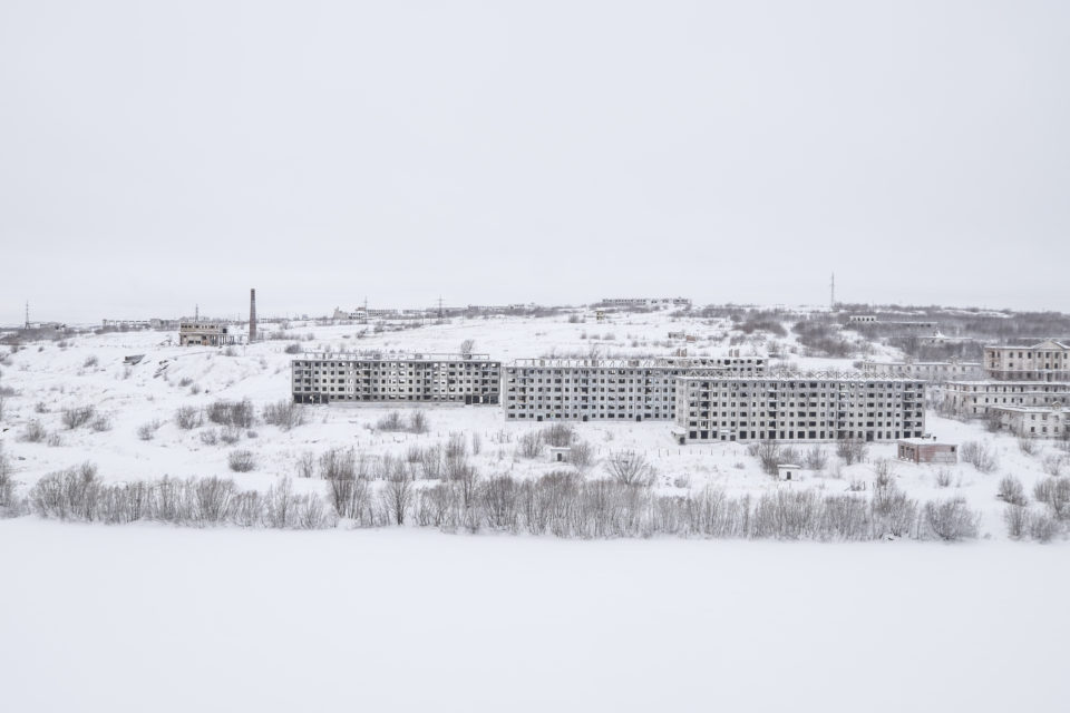 Empty buildings on the banks of the small river Vorkuta.