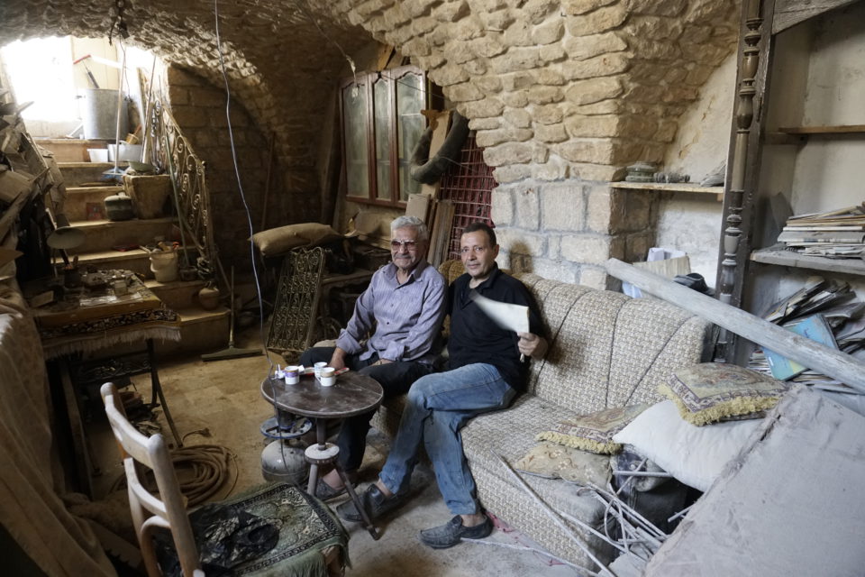 Walid Hinjo (left) his house was entirely destroyed with the exception of the basement. He conditioned it as temporary home while he rebuilds his house with the money from his retirement. 